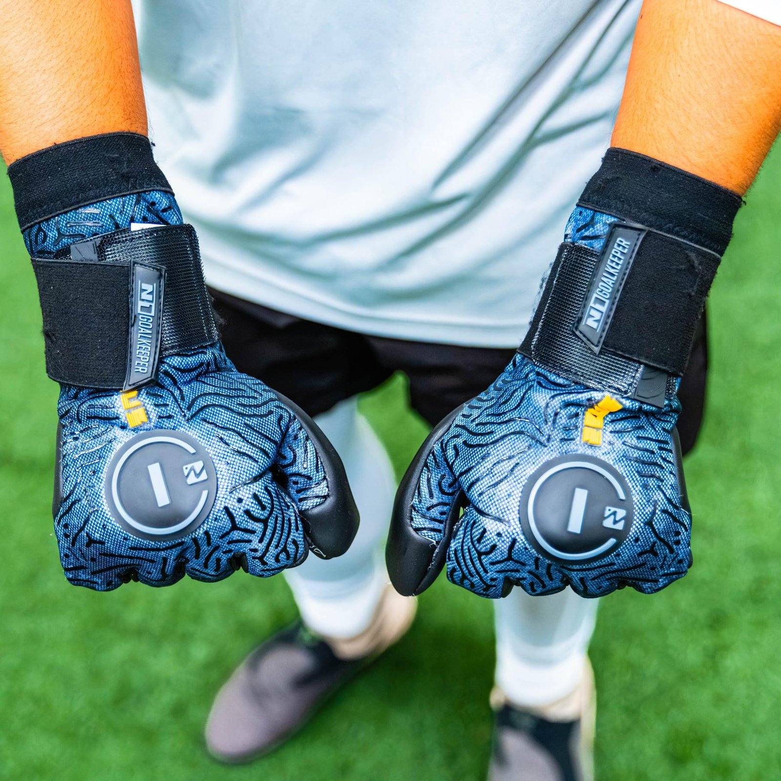Young goalkeeper showing a pair of N1 goalkeeper gloves